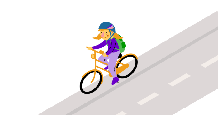 Tyttö ajaa polkupyörällä reppu selässään.