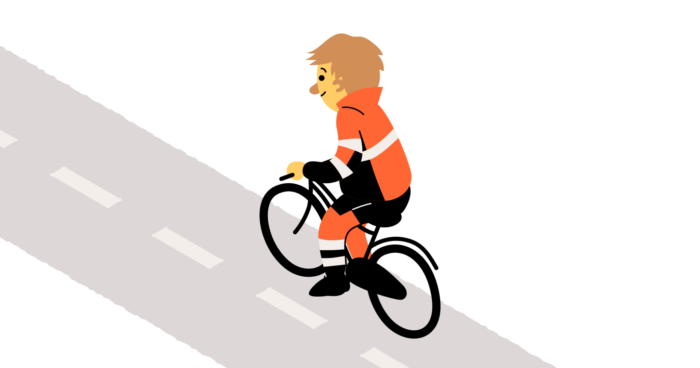 Oranssiin työasuun pukeutunut mies polkee pyörällä ylämäkeä.